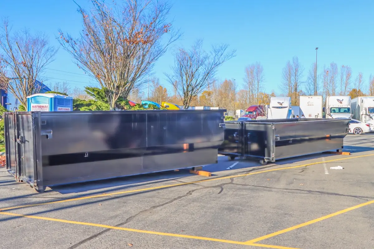 Professional dumpster rental service with roll-off container on residential driveway in Southchase